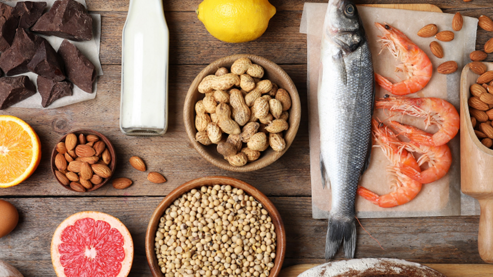 photo of chocolate, milk, fish, peanuts, almonds, bread 