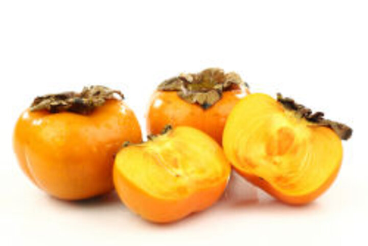 photo of whole and halved persimmons
