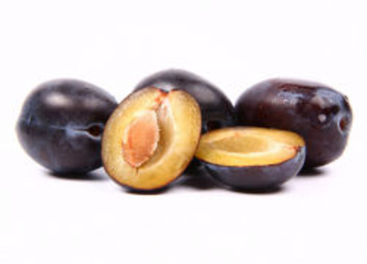 photo of whole and halved prunes